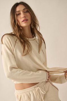 Solid ribbed knit top. Round neckline. Long raglan sleeves. Contrast stitching throughout. Relaxed fit. 67% Polyester, 29% Cotton, 4% Spandex. Imported. Designed in LA. Model wears size S. Easy Does It, Rib Knit Top, Ribbed Knit Top, Top Round, Contrast Stitch, Raglan Sleeve, Chambray, Round Neckline, Knit Top