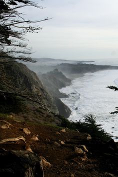 an ocean view from the top of a cliff