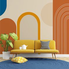 a living room with an orange couch and potted plant on the floor next to it