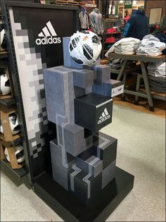 a display in a store with soccer balls on top of cubes that are stacked together