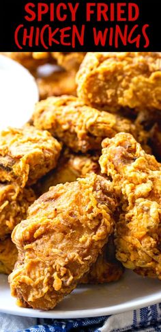 fried chicken wings on a white plate with text overlay that reads spicy fried chicken wings