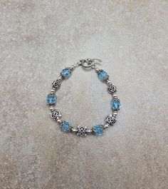 one of a kind sterling bracelet, vintage beaded bracelet, blue Swarovski jewelry Sterling Silver and Swarovski Crystal Handmade Bracelet 7 " all 4mm round beads are sterling silver. All square spacer beads, bead caps and toggle clasp are Bali sterling silver. Swarovski crystals are 8mm round aquamarine Check out my other jewelry at https://loveofjewelryshop.etsy.com *All of my Swarovski crystal bracelets, earrings, and necklaces are my own design using beads I purchased over 20 years ago. Handmade Blue Sterling Silver Charm Bracelet, Handmade Adjustable Sterling Silver Rosary Bracelet, Silver Jewelry With Birthstone Round Beads, Blue Faceted Beads Bracelet, Silver Jewelry With Round Birthstone Beads, Blue Vintage Nickel Free Bracelets, Vintage Blue Nickel-free Bracelets, Vintage Blue Nickel-free Bracelet, Handmade Blue Sterling Silver Beaded Bracelets