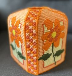 an orange and white box with flowers on it