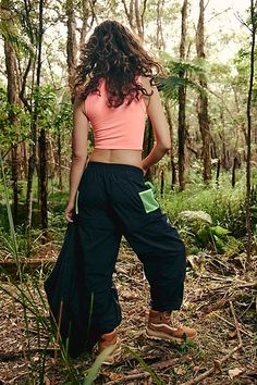 Made for your next hiking trip, these convertible pants feature a high-rise fit and cargo-inspired pockets with cinched bottom hems. **Fit:** High-rise, slouchy, relaxed fit, ankle-length **Features:** Durable, water-resistant fabrication; convertible design that zips off and turns into shorts, stretchy elastic waistband, zip-fly and button closure, belt loops at waistband, zippered pockets at legs, pockets with snap-button closures, contrast trim **Why We | Morning Meadow Hike Pants by FP Movem Summer Hiking Cargo Pants With Pockets, Summer Cargo Pants With Pockets For Hiking, Summer Hiking Cargo Pants With Cargo Pockets, Summer Wide Leg Cargo Pants For Outdoor Activities, Summer Utility Parachute Pants For Outdoor Activities, Functional Cargo Pants For Summer Outdoor Activities, Functional Summer Cargo Pants For Hiking, Functional Summer Cargo Hiking Pants, Summer Parachute Pants With Side Pockets For Outdoor