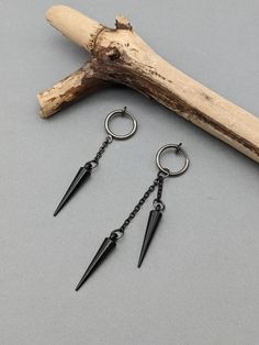 Clip-on spike earring, Black matte spike earring, Spike dangle, Spike gift, Gothic earring, Acrylic dangle, Black dangle, Matt black earring Two style spike earring with chain and clip-on hook.EAR DON'T HAVE TO BE PIERCED. 1. style earring with one chain total length 2,05 Inches ( 52 mm )         Spike charm length 0.9 Inches (22 mm ) 2. style earring with two chains total length   2,76 inches /7,0 cm/     The length of the longest chain 0,98 inches /2,5 cm/     The length of the shortest chain 0,39 inches /1,0 cm/         Spike charm length 0.9 Inches (22 mm )         Clip-on circle size 14 mm  Choose:1 of 2 hook style. Earring is really lightweight and comfortable to wear. It looks the same in both the right ear and the left ear. Modern and trendy earring NOTE: Delivery time to Europe is Black Gothic Jewelry With Spikes, Black Punk Jewelry With Spikes, Black Metal Jewelry With Spikes, Black Edgy Dangle Earrings, Edgy Black Dangle Earrings, Black Metal Spiked Jewelry, Edgy Gunmetal Jewelry, Edgy Dangle Plug Earrings, Edgy Nickel-free Dangle Plug Earrings