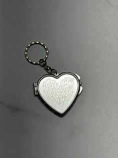 a heart shaped keychain with the words we are married on it