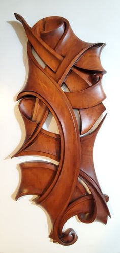 a wooden sculpture on the wall in an art nouveau style with intricate carvings and curves