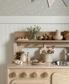 an old fashioned wooden stove top oven with pots and pans on it's burners