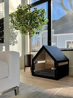 a living room filled with furniture and a fire place in front of a large window