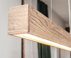 a wooden light fixture hanging from a ceiling