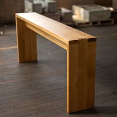 a wooden bench sitting on top of a hard wood floor