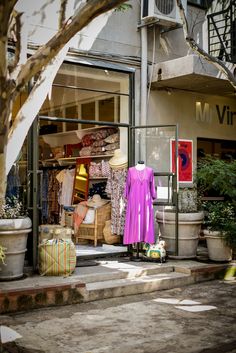 a store front with clothing on display in the window