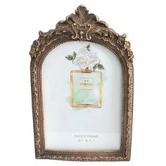 an ornate gold frame with a white flower on it and the word chanel written in french