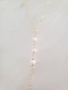 "These dainty and thoughtfully designed necklaces are stunning paired as a set or on their own! Would be wonderful for a bride or as a feminine and lovely touch to your every day. Genuine freshwater pearls are wire wrapped in a minimal/vintage-y/boho style. Made from top quality materials- true 14k gold fill or solid sterling silver, will not tarnish or turn you green, wear 24/7! Secured with an easy to use oval lobster clasp. Lead and nickel free. Excellent for sensitive skin! Come packaged in Delicate 14k Gold Filled Lariat Jewelry, Pearl White Pearl Chain Necklace For Wedding, Elegant Pearl White Chain Necklace For Wedding, Delicate Pearl Lariat Necklace With Pendant, Pearl Chain Necklace With Pearl Charm For Wedding, Pearl Chain Necklace With Pearl Pendant For Wedding, Elegant Layered Pearl Drop Necklace As Gift, Elegant Lariat Jewelry For Wedding, Wedding Pearl Chain Necklace