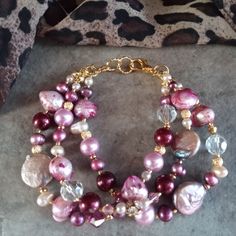 the bracelet is adorned with pink and white pearls