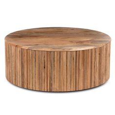 a round wooden table sitting on top of a white floor