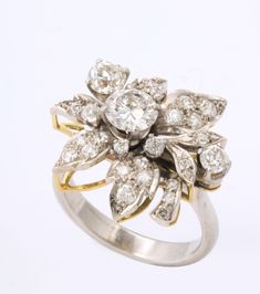 A beautiful articulated floral grouping of diamonds with a center stone approximately .95 cts along with a variety of sizes forming petals and leaves. This is an amazingly lovely ring that can be worn all the time. The total of diamonds is 3.5 carats. Diamond Flower Ring, Lovely Ring, Diamond Flower, Flower Ring, 1 Carat, Cocktail Rings, Jewelry Rings, Diamonds, Engagement Rings