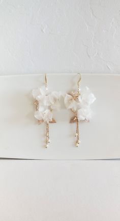 "GOLD FLORAL WEDDING EARRINGS Beautiful feminine long floral earrings for a modern bridal look. They are designed in a beautiful floral pattern with gorgeous hand made in Italy pure silk flowers, crystals and long dangling crystal pearls made in Austria. They are very light weight and easy to wear. They are available for pierced ears only. ♥ COLOR: Gold color metal with off-white silk flowers, clear crystals & white pearls ♥SIZE: Approximately 4 1/4\" long by 2\" wide ♥ WEIGHT: .2 ounces (5g Elegant Handmade Flower Drop Bridal Earrings, Elegant Handmade Flower Bridal Drop Earrings, Party Bridal Drop Earrings With Flower Decoration, Elegant Bridal Earrings With Handmade Gold Flowers, Elegant Gold Bridal Earrings With Handmade Flowers, White Linear Earrings For Wedding, White Dangle Linear Earrings For Wedding, Gold Bridal Drop Earrings With Flower Decoration, Handmade Flower Drop Earrings For Wedding