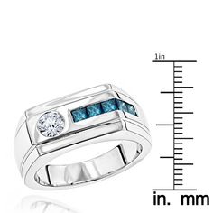 a white gold ring with blue stones on the side and measuring tape in front of it