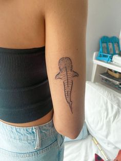 a woman with a shark tattoo on her arm