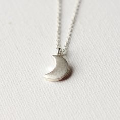 This necklace features the sweetest little crescent moon charm on dainty but sturdy sterling silver cable chain. The charm is about 13mm long (including the loop) and about 7mm wide. A perfect everyday necklace! It is fastened with a sterling spring ring clasp and you can choose your desired length from the drop-down menu above. You can find more celestial jewelry here: www.etsy.com/ca/shop/juliegarland/search?search_query=celestial+jewelry Sterling Silver Half Moon Charm Necklace, Everyday Moon Shape Sterling Silver Charm Necklace, Everyday Moon Shaped Sterling Silver Charm Necklace, Everyday Sterling Silver Moon Charm Necklace, Sterling Silver Moon Charm Necklace For Everyday, Sterling Silver Crescent Moon Charm Necklace, Everyday Sterling Silver Charm Necklace With Moon Charm, Everyday Celestial Sterling Silver Charm Necklaces, Sterling Silver Half Moon Necklace For Everyday