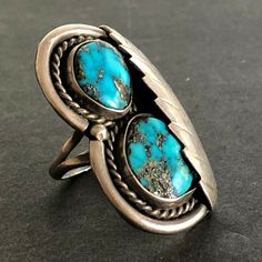 "VINTAGE NAVAJO RING DESCRIPTION: Two breathtaking specimens of high blue Morenci turquoise, this ring will be a treasured addition to your collection of fine vintage Native American jewelry. MEASUREMENTS: Ring face measures 1 5/8\" x 1\" RING SIZE: 7 1/4 WEIGHT: 14.9 grams SIGNED: no STERLING: unmarked, verified sterling silver" Collectible Blue Turquoise Inlay Ring, Antique Untreated Turquoise Jewelry, Collectible Untreated Blue Turquoise Ring, Heirloom Turquoise Ring For Collectors, Southwestern Turquoise Rings With Patina, Southwestern Style Cabochon Rings, Collectible, Southwestern Style Untreated Blue Turquoise Ring, Southwestern Style Cabochon Ring Collectible, Artisan Rings With Patina For Collectors