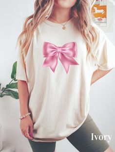 ABOUT OUR Bow Ribbon Coquette Shirt Enjoy fashion with our Coquette Shirt. This T-shirt is perfect as a cute gift or Daughter Gift. This is a Ribbon Shirt, especially for those who want to be fashionable and, at the same time, have a cute and nice look Look no further! This trendy Coquette Bow Ribbon Shirt is unique and practical for Girls, Daughter or Moms, combining style and utility. 👉 Unisex T-shirt - 100% Airlume combed and ringspun cotton  - Soft cotton and quality print make users fall i Coquette Shirt, Shirt Coquette, Aesthetic Gift, Ribbon Shirt, Bow Ribbon, Coquette Bow, Cottagecore Aesthetic, Gift For Daughter, Cute Gift