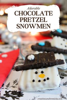 chocolate pretzel snowmen are sitting on a table