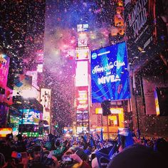 the crowd is celebrating in times square at new year's eve with confetti