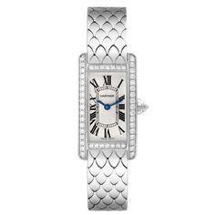 Cartier Tank Americaine White Gold Diamond Bezel Ladies Watch WB710009. Quartz movement. 18K white gold case 19.0 x 34.8 mm. Octagonal crown set with an original Cartier factory faceted diamond. 18k white gold original Cartier factory diamond bezel. Scratch resistant sapphire crystal. Silvered grained dial with black Roman numeral hour markers and an inner minute track. Sword-shaped blue hands. 18K white gold bracelet with hidden butterfly clasp. Fits a 6 1/4" wrist. Luxury Platinum Wedding Jewelry And Watches, Cartier White Gold Diamond Watch For Anniversary, Cartier Diamond Watch In White Gold For Anniversary, White Gold Wedding Watches With Diamond Hour Markers, Cartier Jewelry With Round Dial For Evening, Cartier Jewelry With Palladium Hardware For Anniversary, Timeless White Diamond Watch In Platinum, Luxury White Gold Diamond Watch For Wedding, White Gold Watches With Diamond Hour Markers For Evening