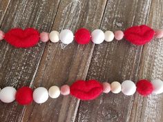 red and white felt heart garland on wooden table