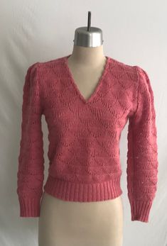 "Sweet 1980's (could be late 1970's) Diane Von Furstenburg rose pink sweater with the most darling puff sleeves, v-neck with shell edging and with an overall feminine boho look to it. The knit pattern are shells creating a textured and lacy look to the fabric. I believe the knit to be machine made, but the edging along the neck would have been hand crafted.  Sweater is clean and in great condition - there's some light pilling here and there.   Label: Diane Von Furstenburg - 100% Acrylic - Machin Pink Button-up Knit Sweater, Retro Pink Long Sleeve Sweater, Hand-knitted Pink Cotton Sweater, Vintage Pink Spring Sweater, Cottagecore Sweater, Pink Textured Knit V-neck Sweater, Puff Sleeve Sweater, Boho Sweater, Lace Sweater