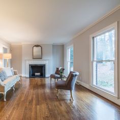 an empty living room with hard wood floors