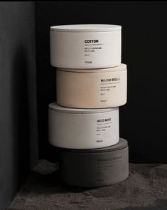 five white and black containers stacked on top of each other