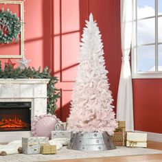 a decorated christmas tree in front of a fireplace