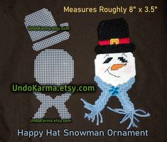 an embroidered snowman ornament with a hat on it