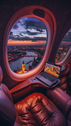 A luxurious business class seat on a plane overlooks London's illuminated Big Ben and River Thames at sunset, with a laptop on the table reflecting the vibrant scene. Europe Luxury Aesthetic, Travelling For Work Aesthetic, Travel Destinations Aesthetic, Flying Business Class Aesthetic, Remote Work Aesthetic Travel, New Business Aesthetic, New Experiences Aesthetic, Luxury Lifestyle Photography, Work Travel Aesthetic