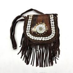 Suede cowhide bag This unique suede shoulder bag made with real cowhide is a real eye-catcher! The bag is handmade and comes from India, the shoulder bag features a beautiful high-quality cowhide, a double row of shells, a circle of studs, mosaic stones + shells, and gracefully finished around the bag with tassels/fringes that add even more provide a unique style. Sacred cows In India, cows are sacred and cows may not be slaughtered. The bag is therefore made from cows that have died naturally. Mosaic Stones, Shell Bag, Cowhide Bag, Bag Dark, Boho Bag, Stone Mosaic, Tassel Fringe, Ibiza, Bag Making