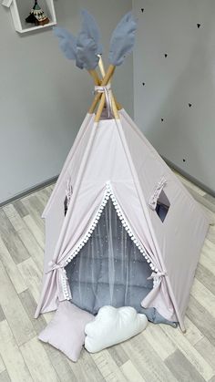 a teepee tent sitting on top of a hard wood floor