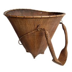 a large woven basket with a tie around it's neck and shoulder looped at the end