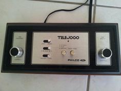 an old radio sitting on top of a white tile floor next to a black and silver panel