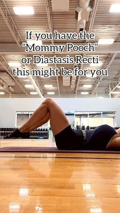 a woman laying on top of a wooden floor in a gym with the caption if you have the mommy pooch or diatasis recti this might be for you