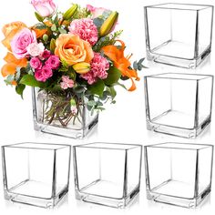 four clear square vases with flowers in them