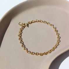 Picture a sleek and elegant gold bracelet, designed with minimalism in mind. It features a delicate chain crafted from shimmering 14k gold fill, offering a subtle yet luxurious glow. This piece embodies sophistication and refinement, perfect for adding a touch of timeless elegance to any ensemble. DETAILS14k gold fill Hypoallergenic, water proof, and nickel free To determine your wrist size, use a tape measure or ribbon around your wrist, then measure against a ruler. Elegant Gold Bracelet, Gold Jewelry Gift, Forever Jewelry, Delicate Chain, Solid Gold Jewelry, Pendant Bracelet, Tape Measure, Water Proof, Wedding Men