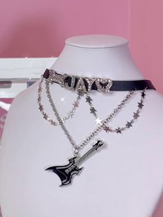 Elevate your accessory game with this chic Rhinestoned Letters Y2K Stars Guitar Pendant Black PU Choker. This statement piece features a sleek black PU leather band that comfortably wraps around your neck. The choker is adorned with dazzling rhinestoned letters that spell out a retro Y2K vibe, making it a perfect addition for anyone looking to embrace early 2000s fashion. The standout guitar pendant, embellished with tiny stars, adds a touch of rockstar glam. Black Rock Jewelry, Trendy Black Bling Jewelry, Rockstar Glam, Y2k Stars, Guitar Pendant, Steampunk Fashion Female, Steampunk Fashion Male, Gothic Skirts, Early 2000s Fashion