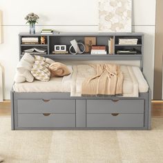 a bed with storage drawers underneath it in a room