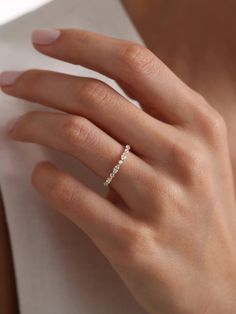 a woman's hand with a diamond ring on it