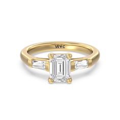 an emerald cut diamond engagement ring with three baguets