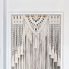 an image of a white wall hanging with tassels