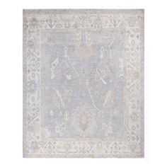 an antique rug with blue and white colors on the ground, in front of a white background